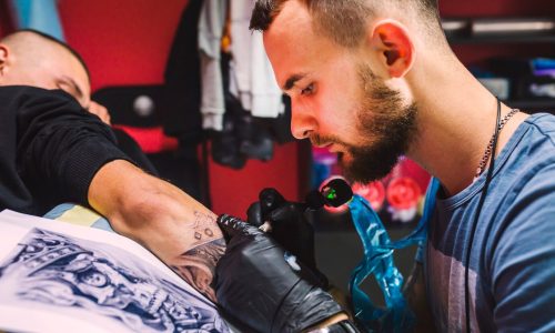 adult-man-working-with-tattoo-pen-arm_23-2147834089