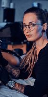 beautiful-creative-master-with-dreadlocks-is-working-new-peace-big-leg-tattoo-customer_613910-2929