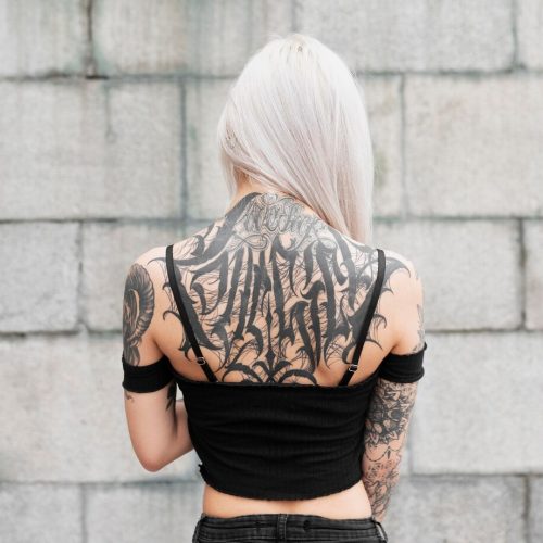 medium-shot-woman-with-tattoos-back_23-2149028743