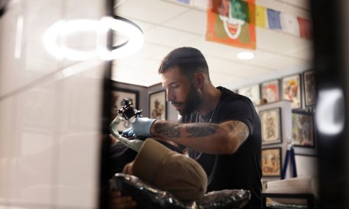 tattoo-artist-doing-his-job-medium-shot_23-2149525945
