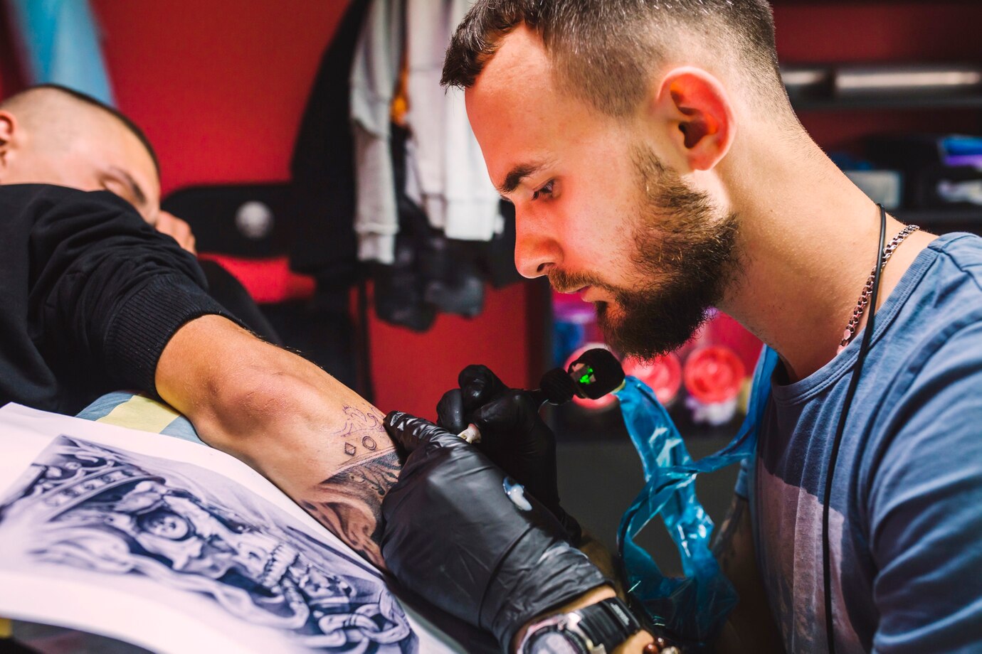 adult-man-working-with-tattoo-pen-arm_23-2147834089